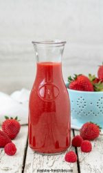 Berry Sauce in carafe with strawberries and raspberries