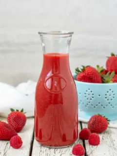 Berry Sauce in carafe with strawberries and raspberries