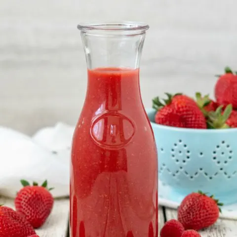 Berry Sauce in carafe with strawberries and raspberries