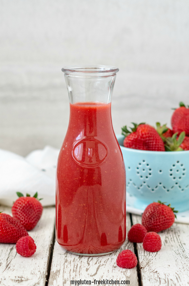 Berry Sauce in carafe with strawberries and raspberries