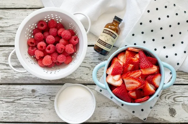 Ingredients for Berry Sauce Recipe. Strawberries, raspberries, sugar and vanilla extract.