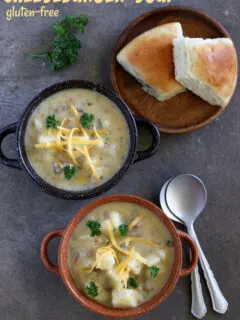 2 bowls of gluten-free cheeseburger soup with spoons and rolls