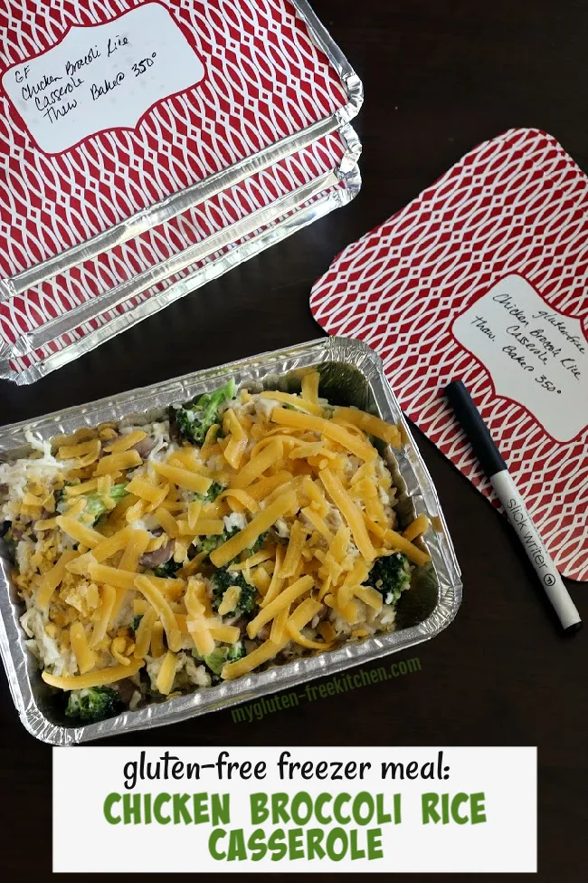 four baking pans with chicken broccoli rice casserole and a pan for labeling the lids