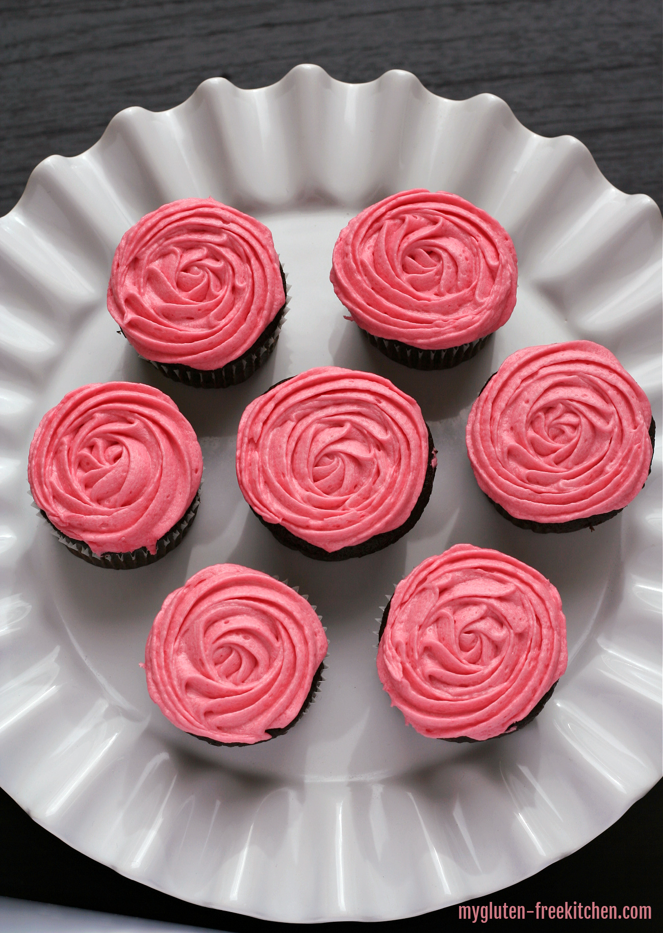 gluten-free chocolate raspberry cupcakes on white cake plate