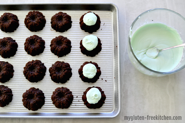 Putting Mint Frosting on mini gluten-free chocolate cakes
