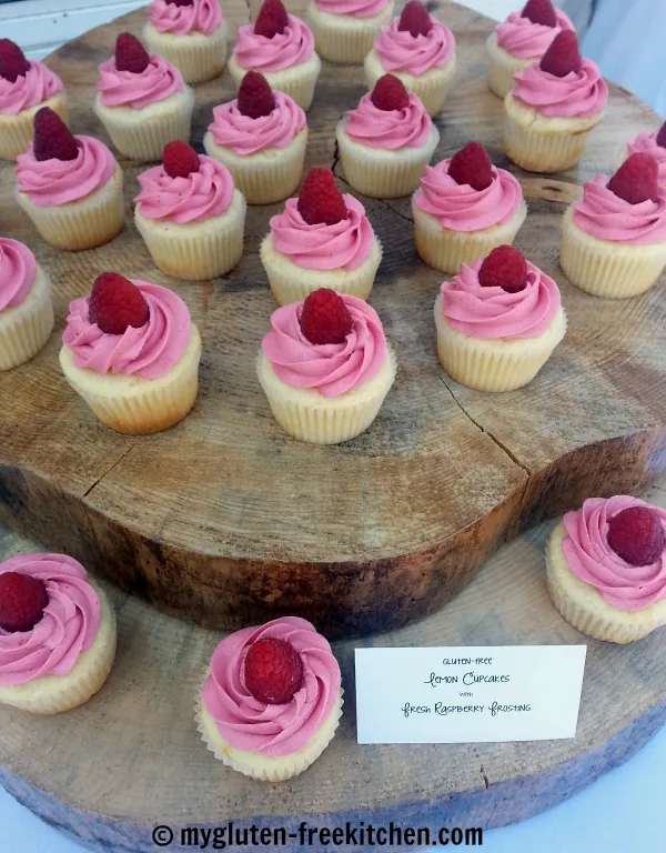 Gluten-free Lemon Cupcakes with Raspberry Buttercream for a wedding! So cute displayed on this tree trunk cake stand!