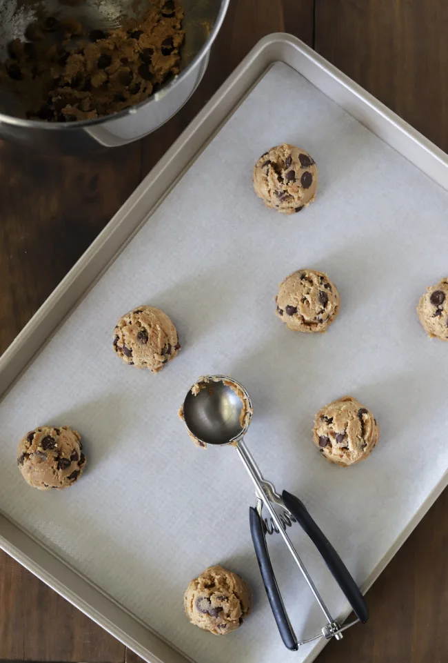Scooping gluten-free chocolate chip cookie dough onto pan