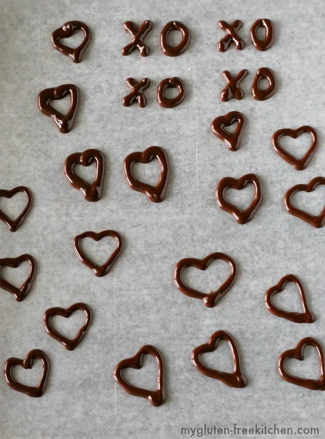 Practicing making Chocolate Heart Decorations. Using melted chocolate with a bit of shortening to make chocolate decorations.