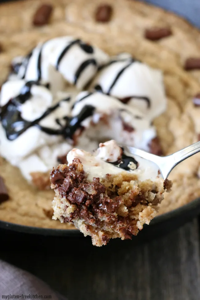 Gluten-free Chocolate Chunk Skillet Cookie Recipe. Serve family style by handing everyone in the family a spoon to dig in!