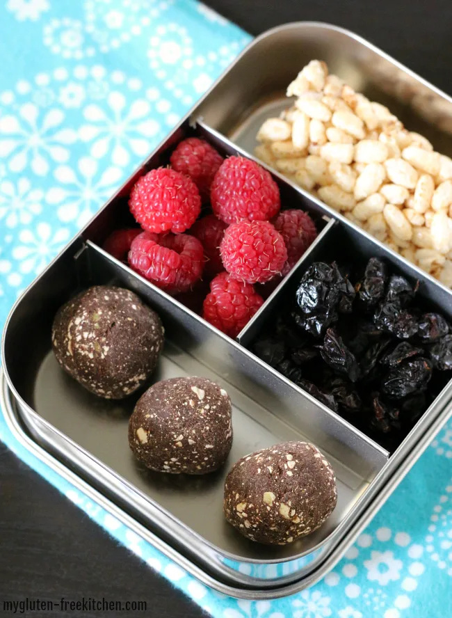 Gluten-free top 8 free snack box with raspberries cranberries rice cake and protein bites