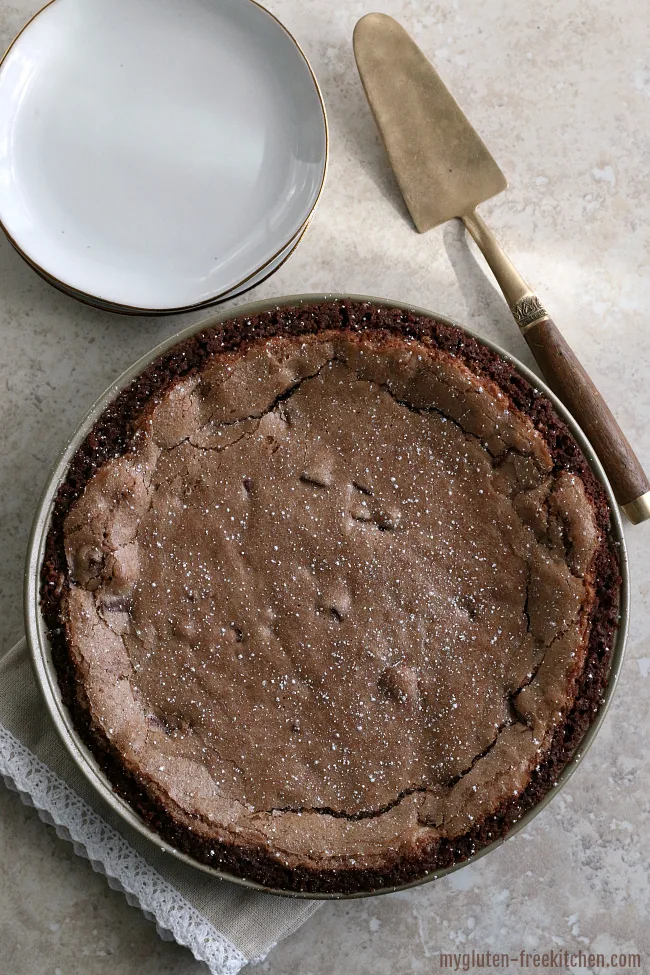 Gluten-free Fudge Pie with Chocolate Crust and powdered sugar sprinkled