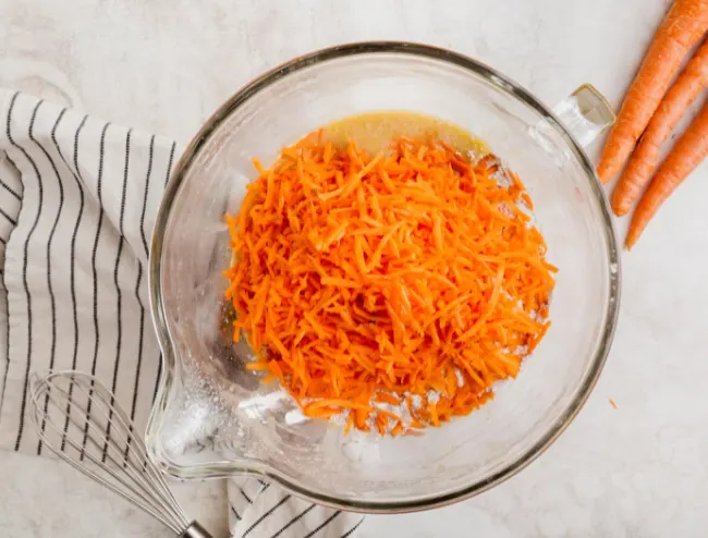 Shredded carrots ready to stir in for carrot cake