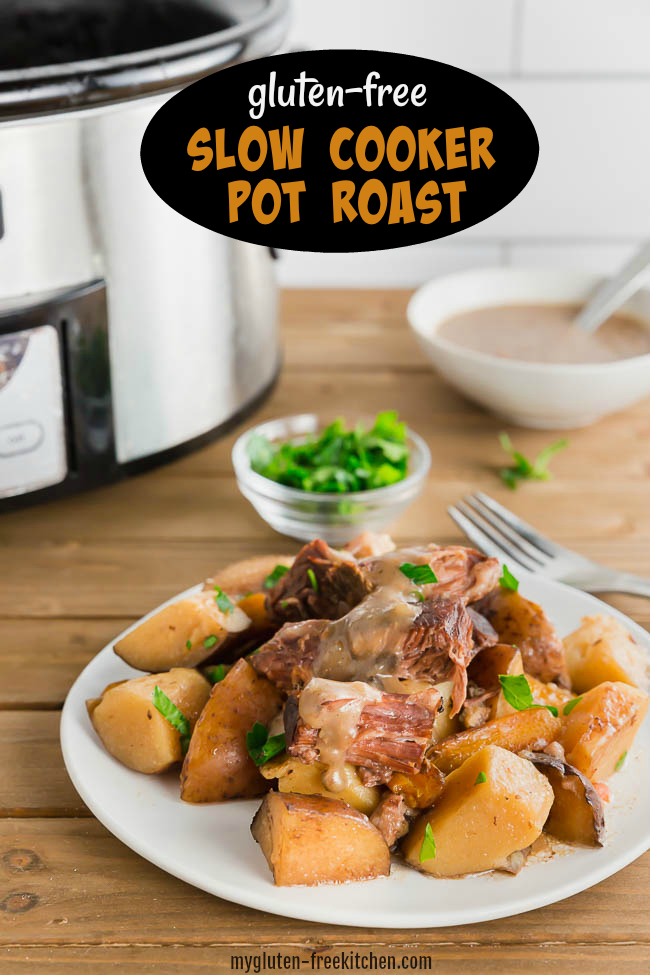 Gluten-free pot roast with potatoes on plate with a crockpot in background