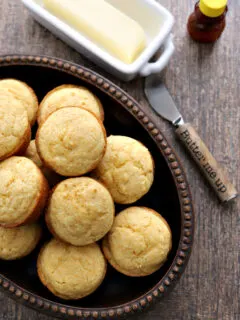 Gluten-free Corn Muffins in bowl with knife and butter