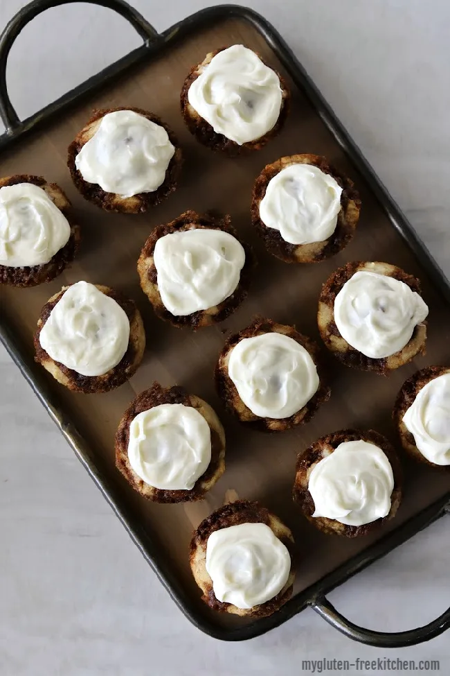 one dozen gluten-free cinnamon roll muffins on platter