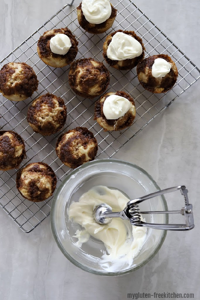 Putting Frosting on gluten-free cinnamon muffins